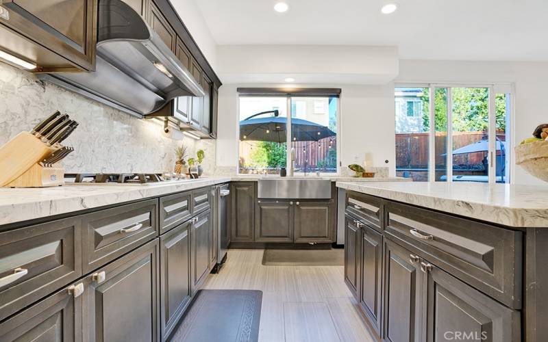 Huge is to cook with ample storage, stainless farmhouse sink making it easy to wash your large pots and pans, gas cooktop, and professional style range hood.