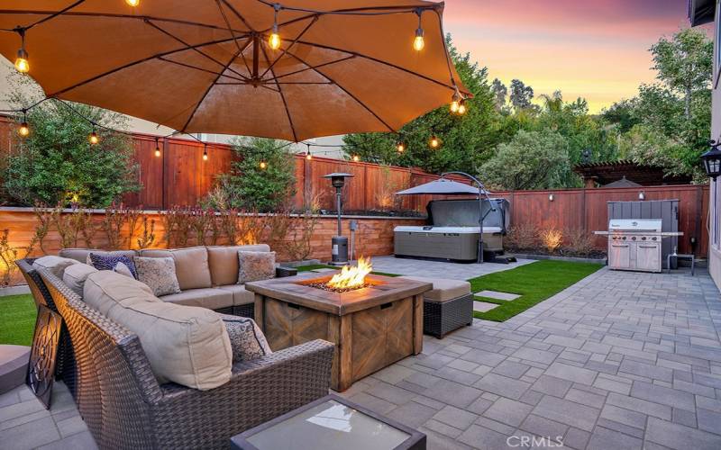 Beautiful Pavers, artificial turf, modern retaining wall and landscaping lights