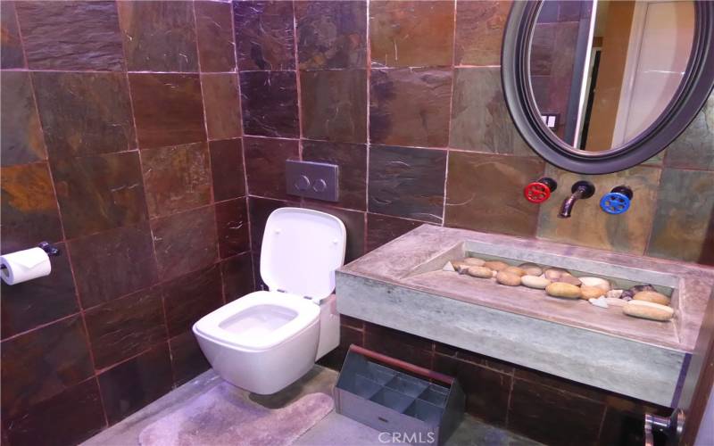 Custon Half Bath with Special Rock Sink & Unique Square Toilet with Two Size Flush Buttons on Wall.