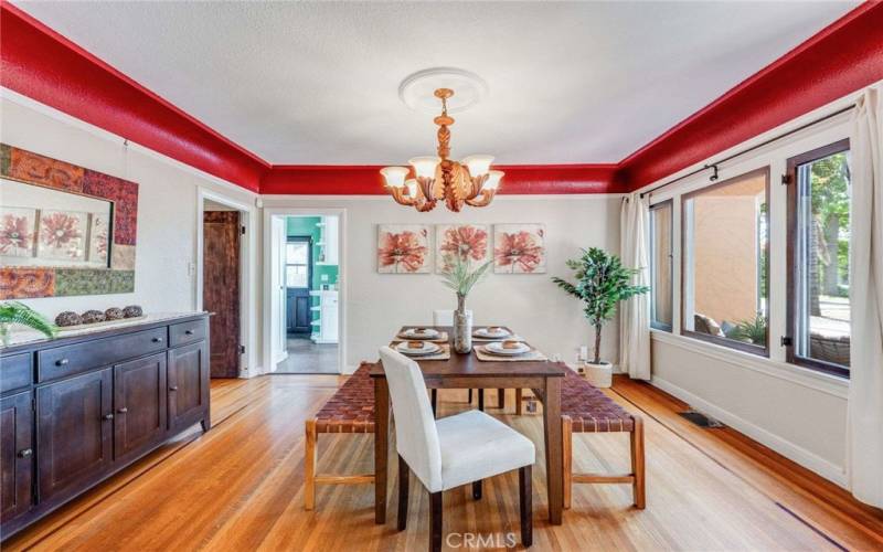 Dining Room complete with large picture windows, refinished original hardwood floors, and picture railing.