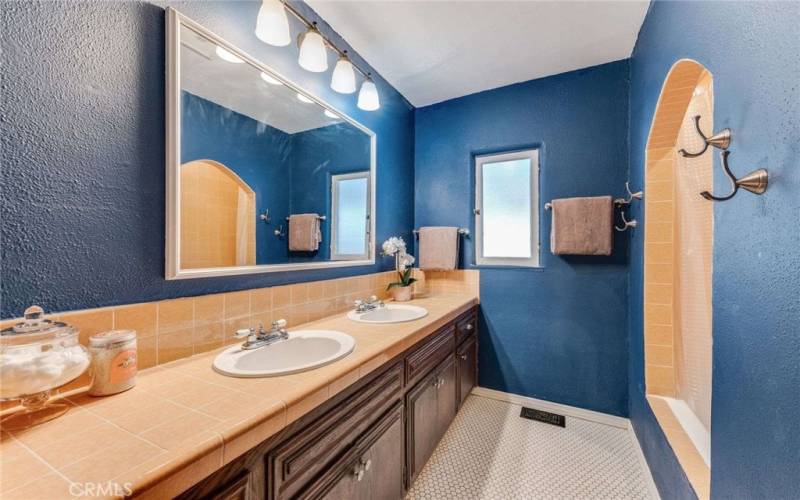 Beautiful Full, Hall Bathroom with a timeless arched entrance to the Tub/Shower and double vanity
