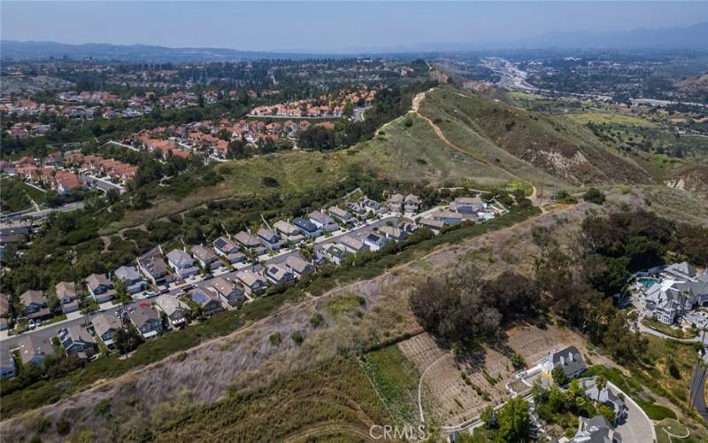 Behind 88 Oakcliff on the other side is Pepper Tree Lane in San Juan Capistrano with multi-million dollar homes.
