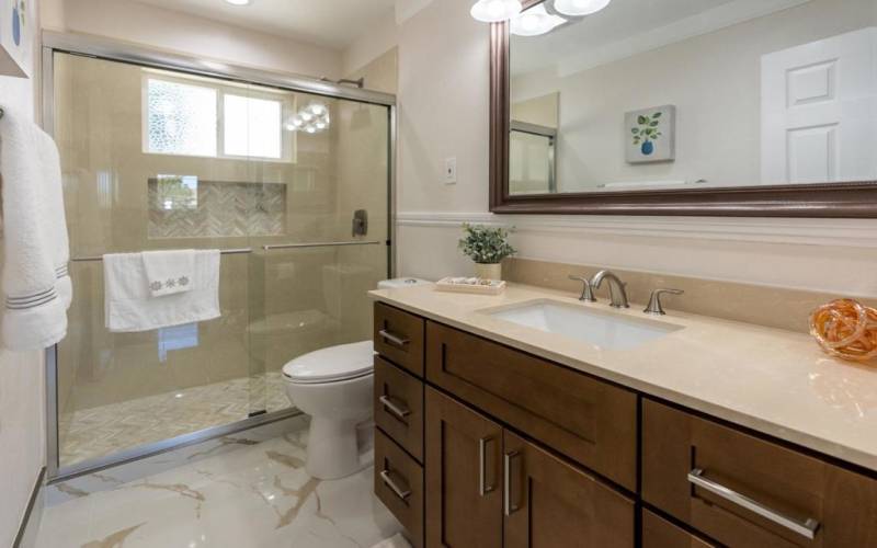 Downstairs guest bathroom. Nice sized, upscale vanity and countertop. Brush-nickel fixtures. Updated