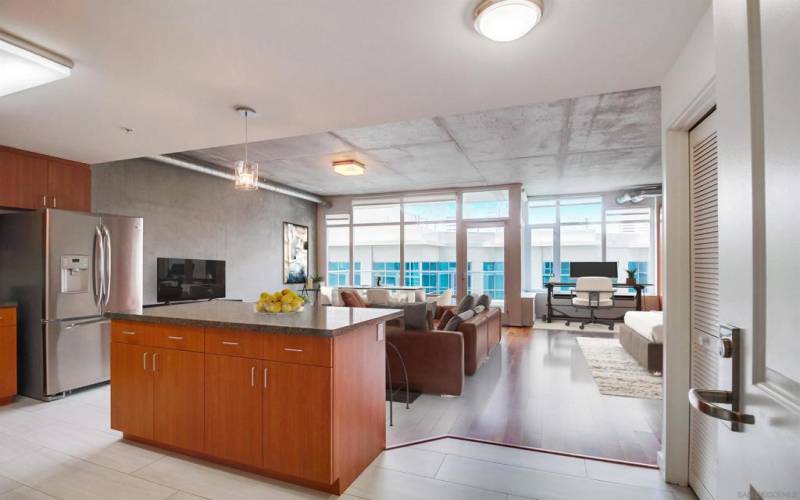 Open floor plan loft living/dining/home office/bedroom area. The bedroom area has two custom-curated, hard-wood closets. Floor-to-ceiling glass walls & door opening to private balcony, exposed a/c ducts& accent cement walls. Upgraded appliances.