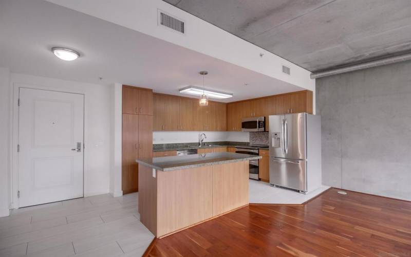Open floor plan loft living/dining/home office/bedroom area. The bedroom area has two custom-curated, hard-wood closets for hanging clothes and drawers. Floor-to-ceiling glass walls & door opening to private balcony, exposed a/c ducts& accent cement walls