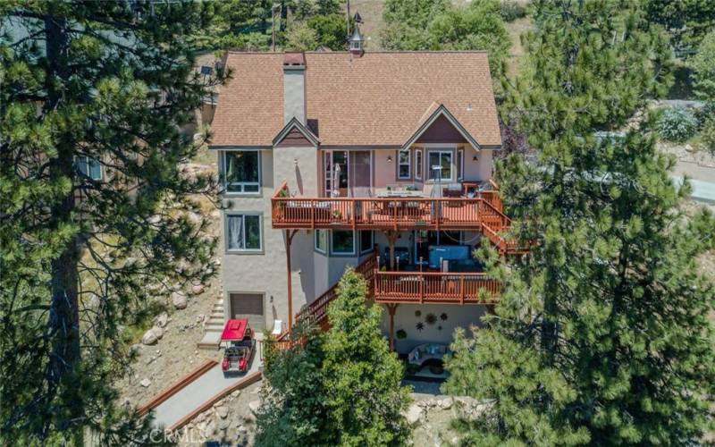 Aerial view of the back of the home showing golf cart garage