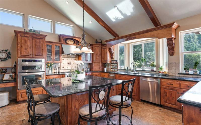 Kitchen has massive center island with wine refrigerator and storage