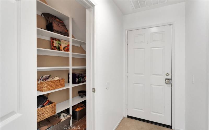 Large additional pantry and storage under the stairwell adjacent to kitchen and family room.