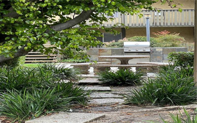 Lovely dining at stone tables and benches in landscaped seating areas