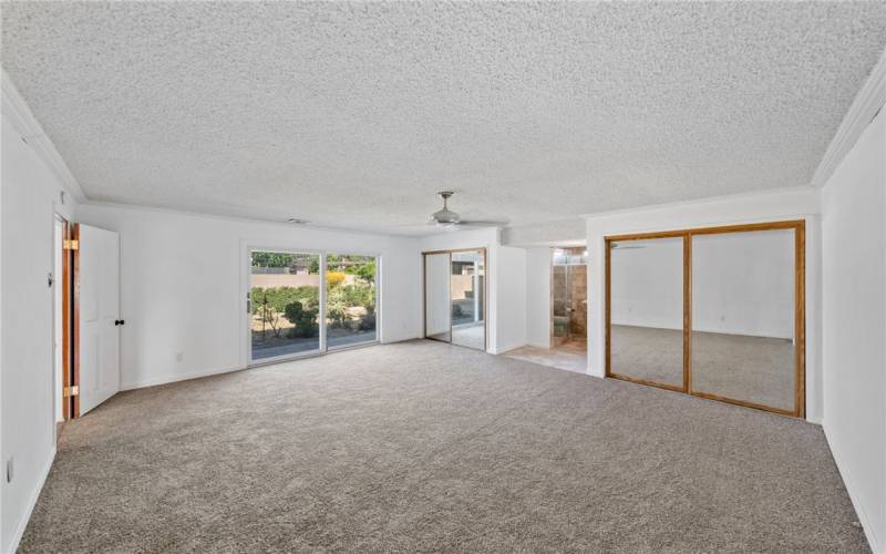 primary bedroom with dual pane sliding glass door that exits to beautiful backyard brand new carpet