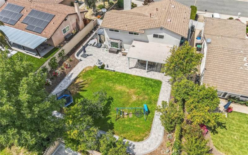 Spacious backyard in circled with pavers.