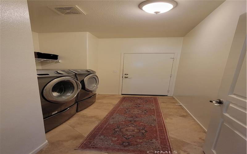 Laundry Room Located Off of The Hallway and Leads to Garage