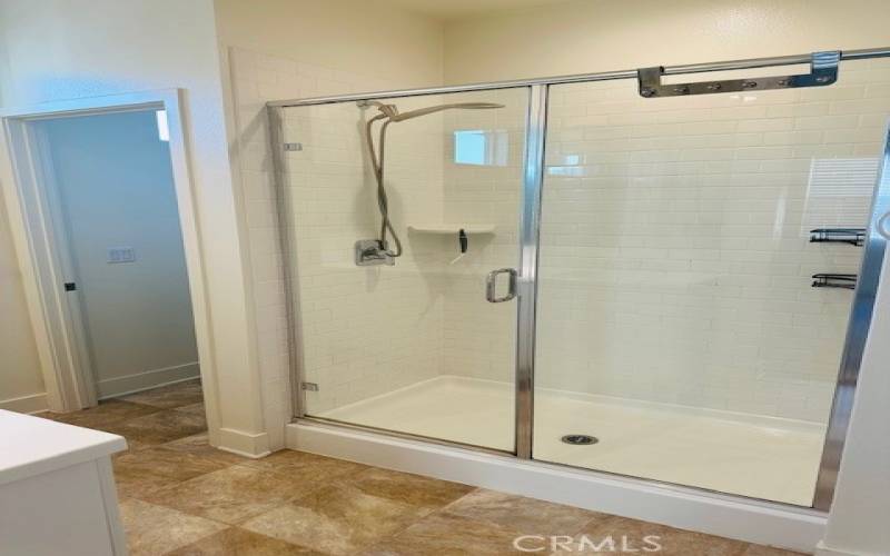 Glass enclosed shower in Primary en suite bathroom
