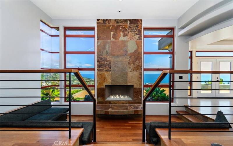Living Room Fireplace surrounded by windows to your ocean view.