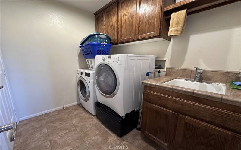 Laundry room with deep tub and plenty of storage.
