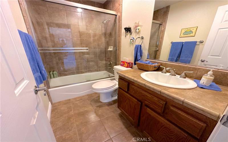 Complete Guest Bath Featuring Glass Shower Doors.