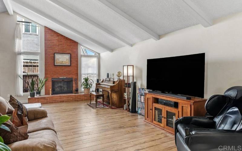 Fireplace, vaulted and beamed ceilings, lots of light, wood tile floors