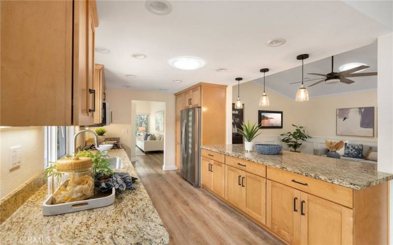 Kitchen opens up to both a dining area and living room space.