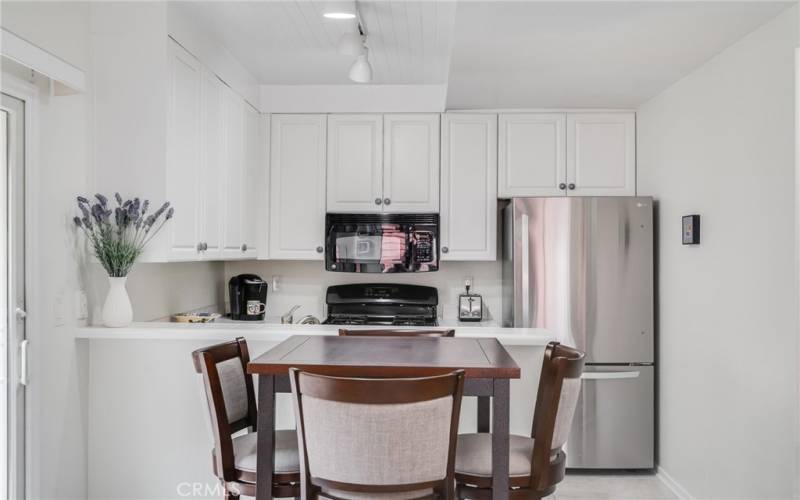 You will enjoy lots of cabinet and countertop space, as well as the conveniently located pantry just off the kitchen to the right of this photo.
