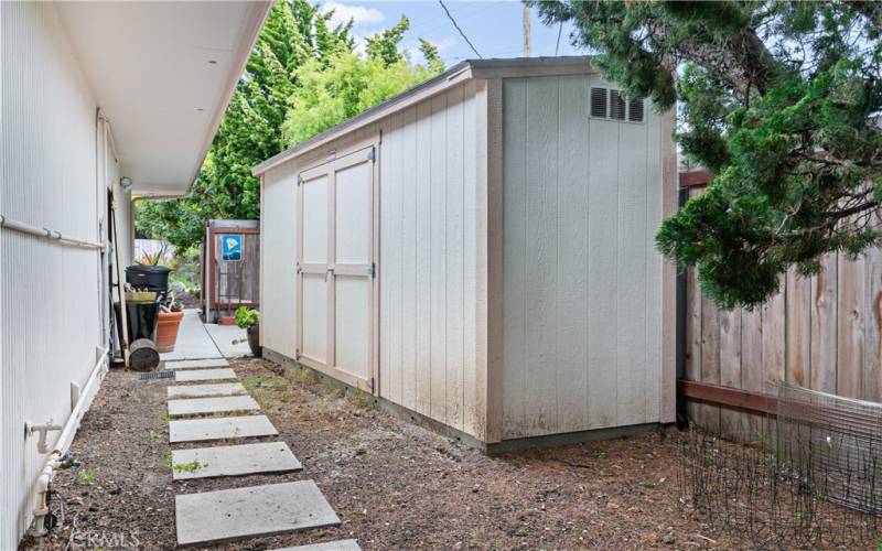 Side yard has a large storage shed