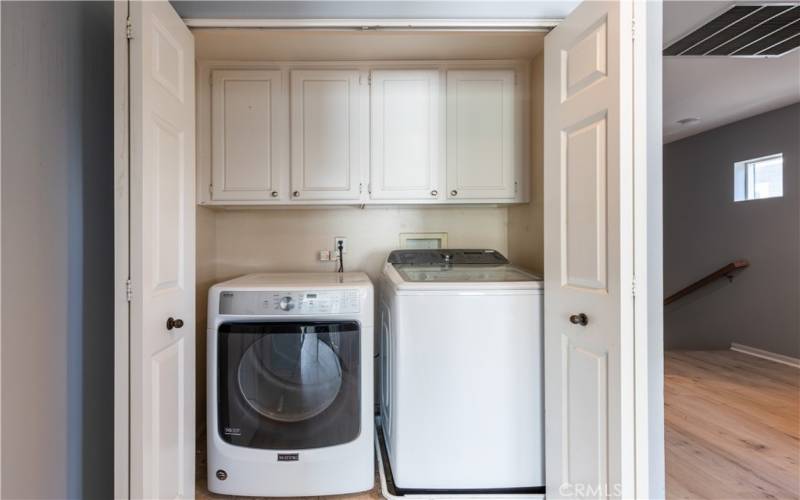 Upstairs laundry large enough for full size washer and dryer plus cabinets