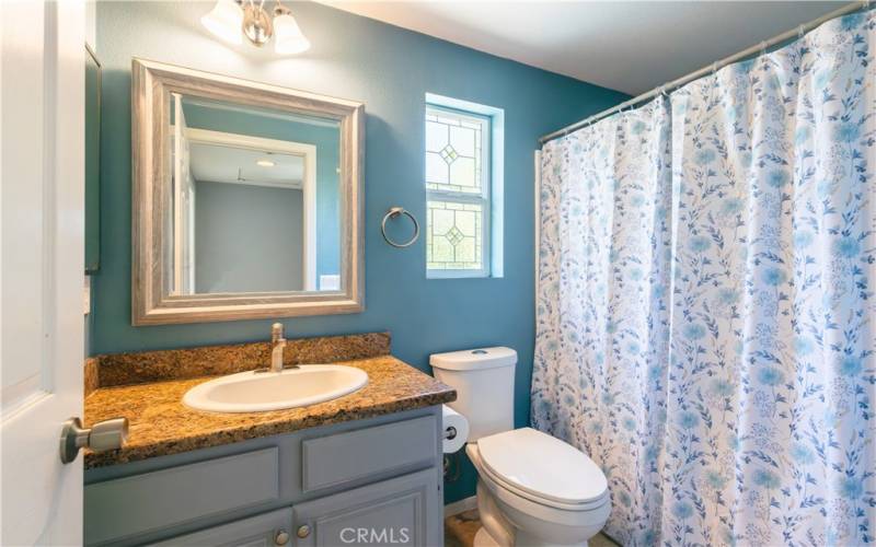 Upstairs secondary bathroom is located on the landing and has leaded glass windows for privacy