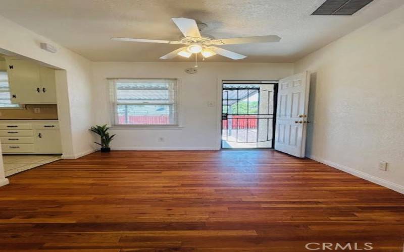 Dinning room with original hard wood flooring along with security back door leading into backyard.