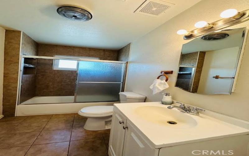 Hallway Bathroom-Recently remodeled, with enclosed tub/shower combo.
