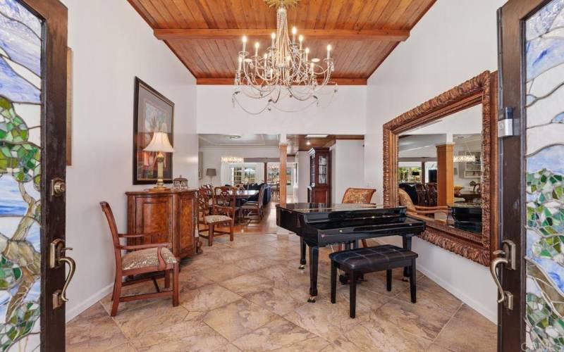 Dramatic and custom with soaring wood beamed ceilings.