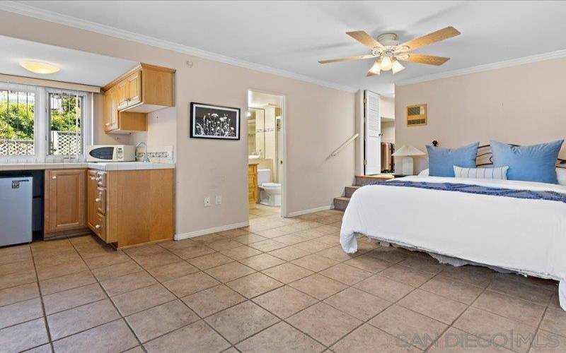 Downstairs studio privately sequestered overlooking canyon, with tile flooring, small kitchen, with storage area.