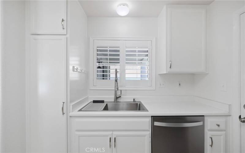 Farm-style sink with view looking onto front porch