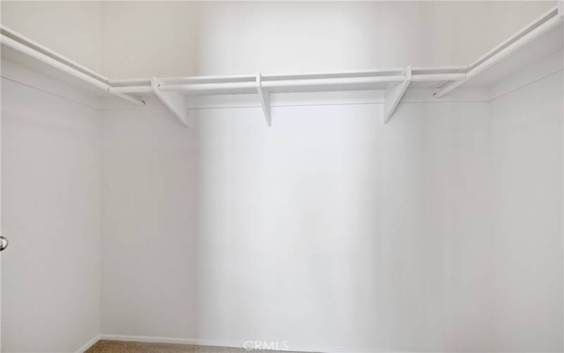 Primary bedroom walk-in closet