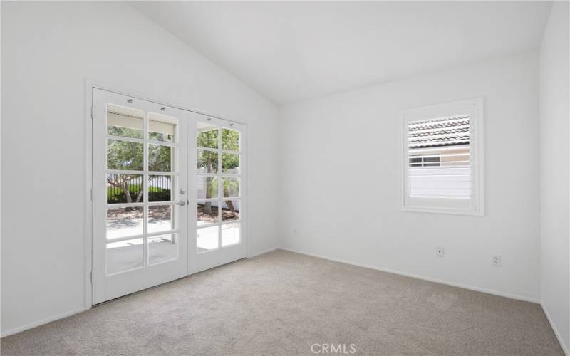 Second bedroom with vaulted ceiling and beautiful French doors