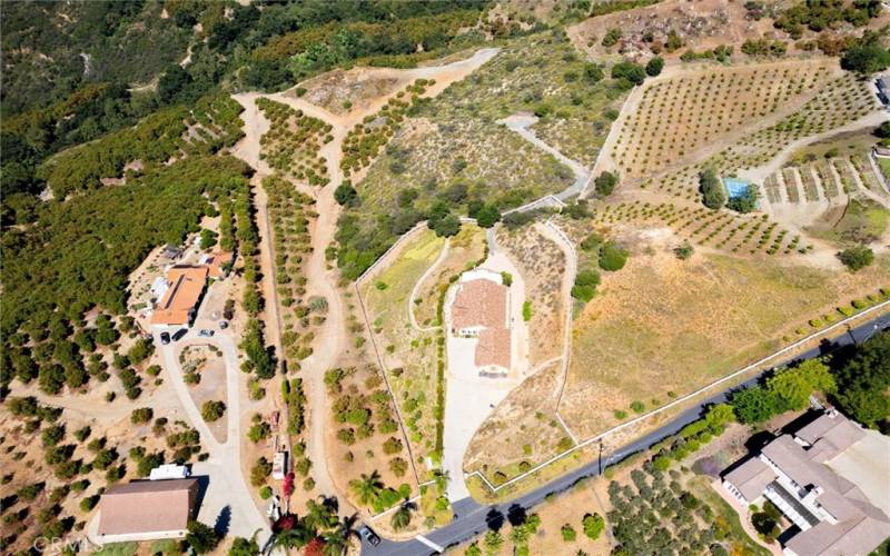 Aerial of the property in the middle of the orchards, with the private street (Corte Bonita) at the bottom of the photo