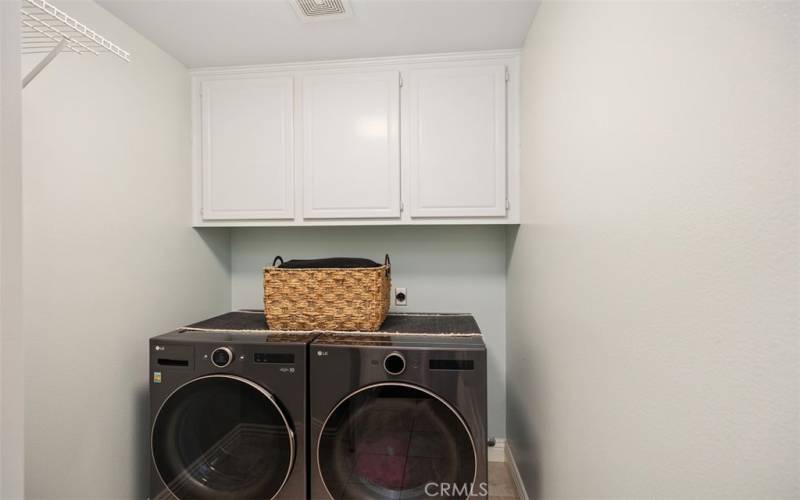 Convenient laundry room with built in storage cabinets. Newer washer/dryer can be included.