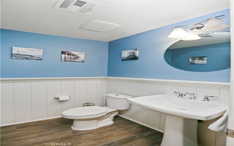 Downstairs half bathroom provides convenience for owner and guests.