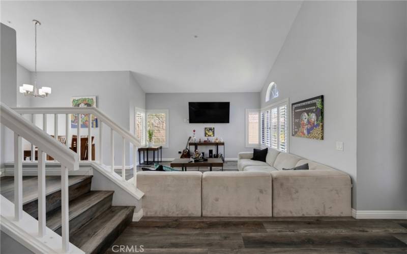 LIVING ROOM BOASTS CATHEDRAL CEILINGS.