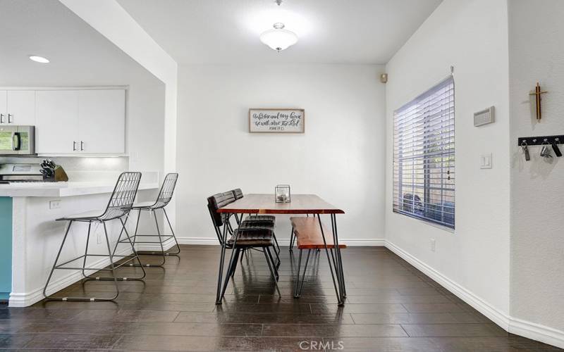 The dining room has plenty of space to accommodate a large dining table as well as bartop stools.