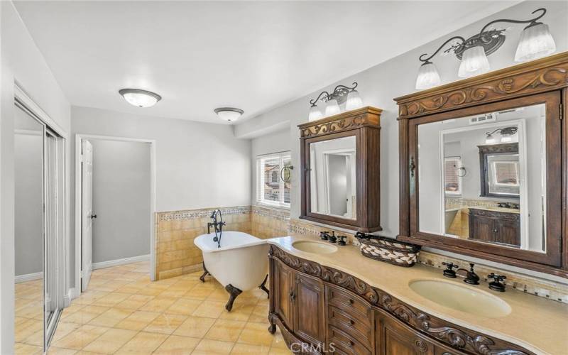 Primary bathroom ...custom tile floors, dual sink vanity, mirrors and soaking tub.
