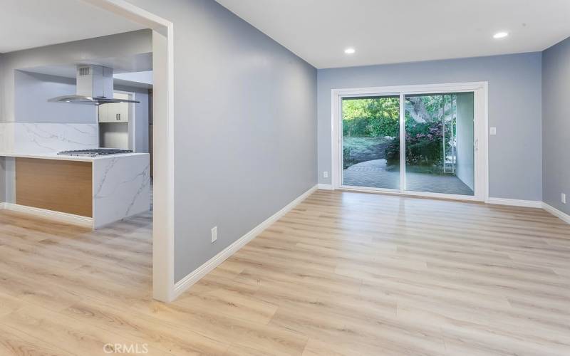 Large separate family room with recessed lights, built-in media niche, sliding glass doors that lead to the backyard and new water-proof laminate floors. BONUS: Potential to be converted to a fourth bedroom.