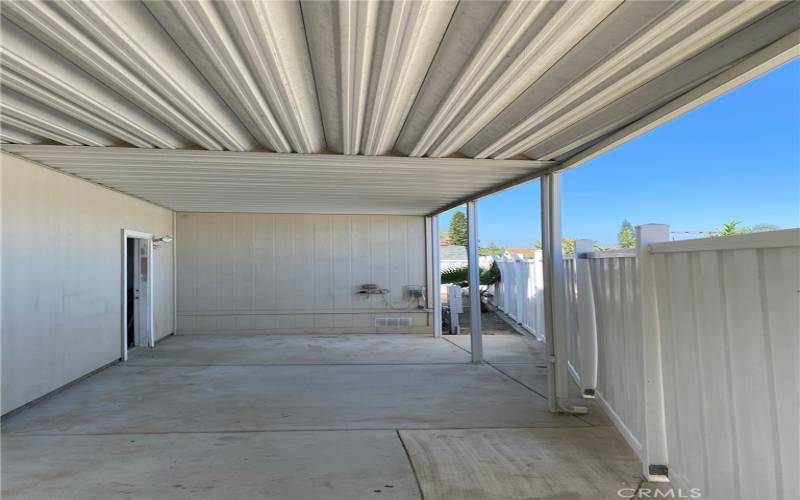 Long view of the patio outside of the back garage door.