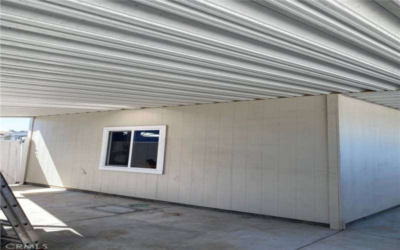 View showing window to the garage. Slight view of vinyl gate into the backyard from the driveway.