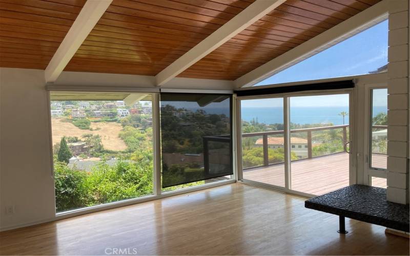 A panoramic ocean and hillside view from your great room.  In the rare times you want to filter the view, you also have shades.