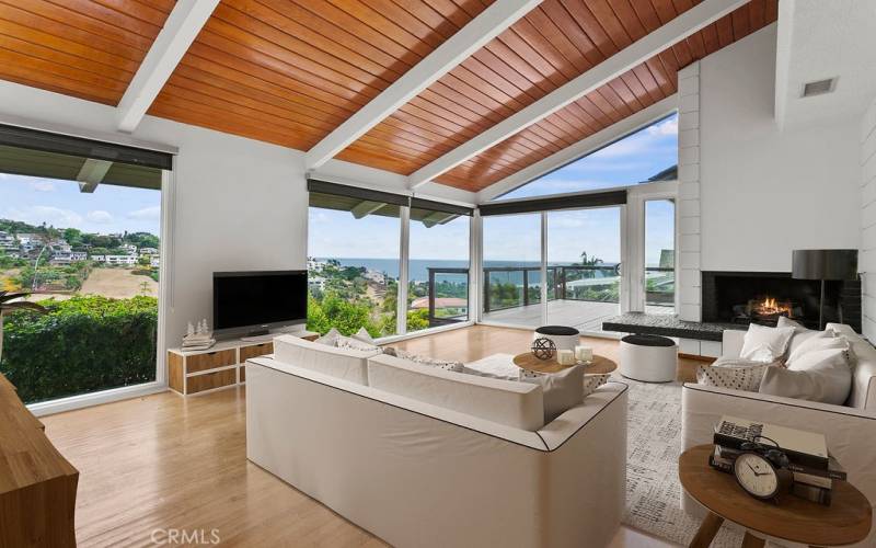 Wow! Year around view from the ocean to the hillside.  Sit in front of your fireplace in winter or enjoy your deck every season.   The vaulted ceiling and wood floors go with every decor.
