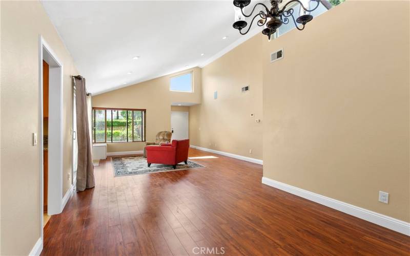 Check out the vaulted ceilings, and clerestory windows for lots of light, year around.  Warm laminate floors for easy care. The great room/living room to dining room are connected and open so it is cozy, yet can handle a large gathering.