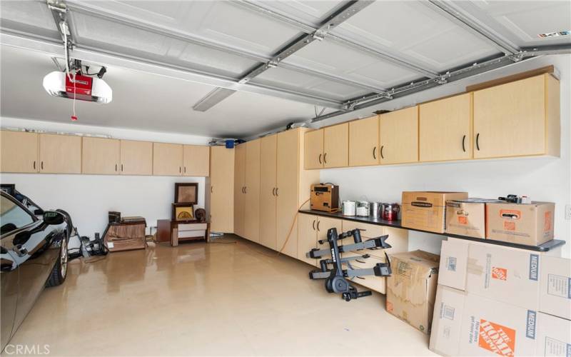 Wow! Double car finished garage has 2 walls of built-in cabinets, epoxy floor, workspace counter and ceiling lights. What a great place for your trophy car or just to work on your hobbies or projects!

