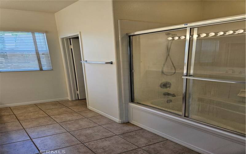 Shower over tub enclosure with sliding glass doors.