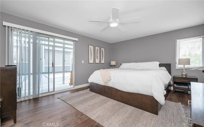 Experience the perfect blend of comfort and style in this bright and spacious bedroom. Featuring sleek hardwood floors, modern ceiling fan, and direct access to the balcony, it's a serene retreat within your home.