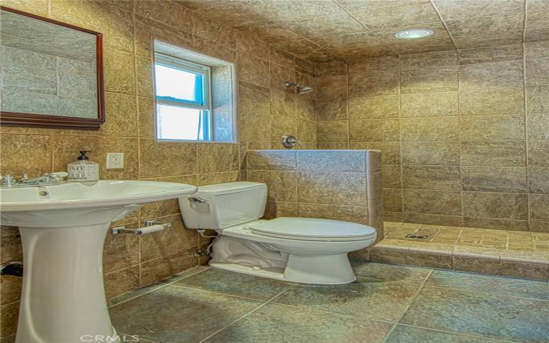 Bathroom adjacent to covered outdoor entertaining area