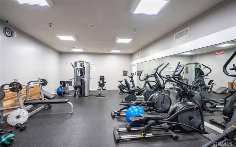 Fitness room with two private locker rooms with spas and saunas.